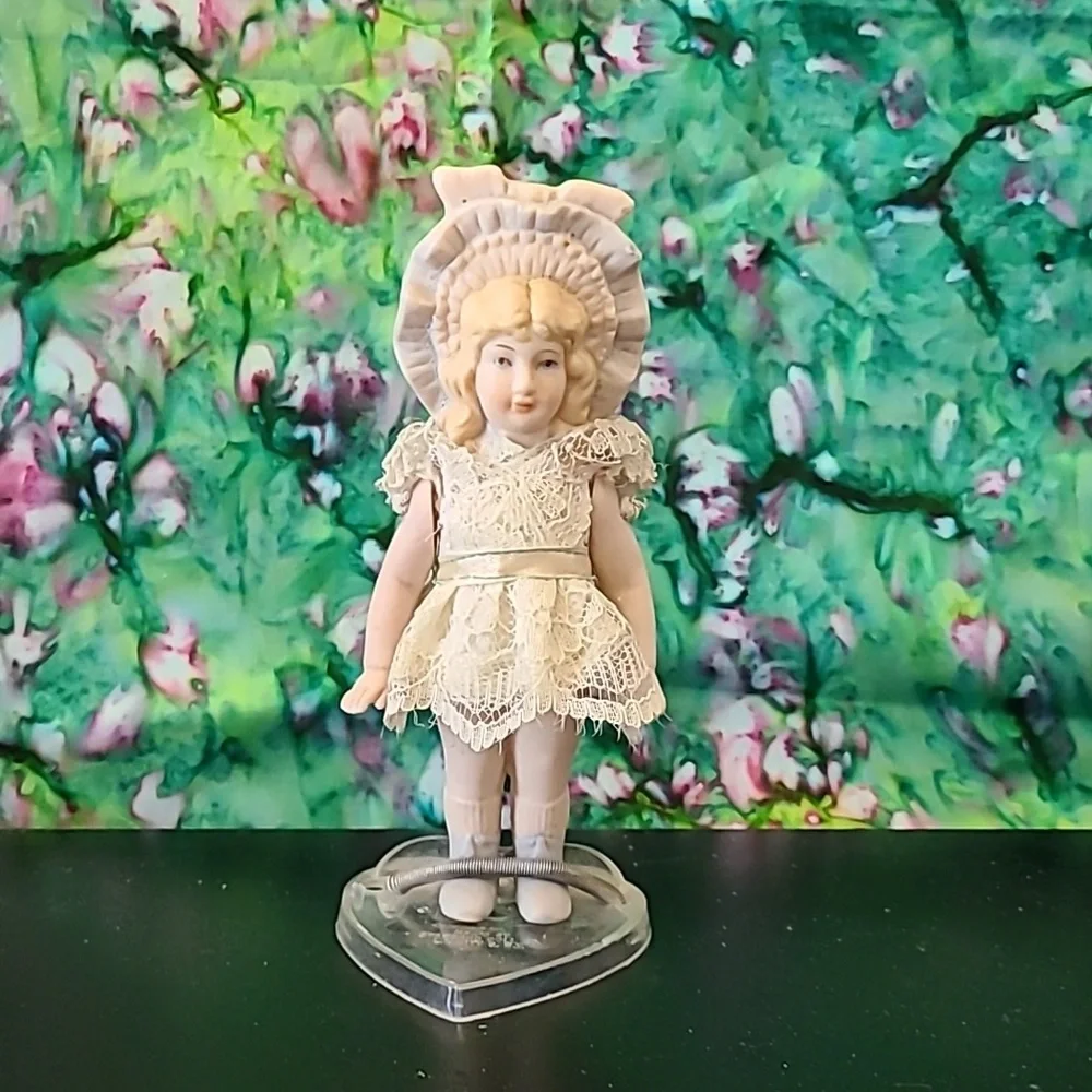 Vintage porcelain doll w/stand